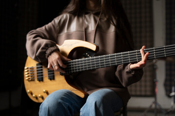 Young Musician Playing electric Guitar in a Studio Setting During a Rehearsal, playing accord - 766506571