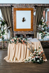 Wedding table for the newlyweds, decorated with flowers and set.
