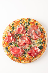 Pizza with prosciutto, ham, arugula, tomatoes, pesto, cheese and parmesan. Italian cuisine. 