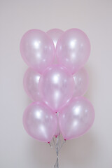 pearlescent pink balloons on white background