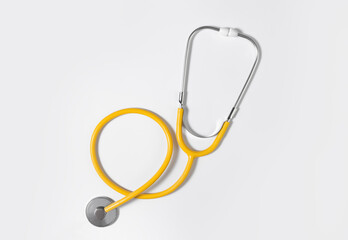 Yellow stethoscope on a light background. Concept of medicine. Health Day.