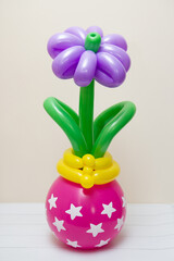purple flower in a vase, flower arrangement of balloons