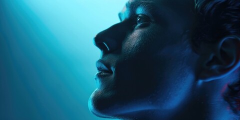 A man's face is shown in a blue light. Scene is mysterious and somewhat eerie