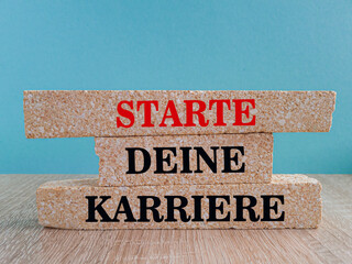 Start your Career symbol. Brick blocks with symbols showing Start your Career in German language....
