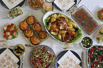 Table full of delicious food in plates, top view.Hearty home-cooked food beautifully presented.