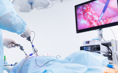 Surgery working with modern laparoscopic equipment camera and lcd screen, sunlight