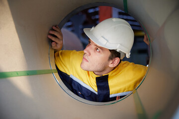 worker or technician checking a roll of industrial aluminum metal material in the factory