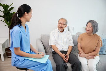 nurse or caregiver meeting and talking with about health with senior couple