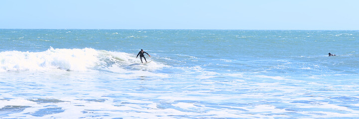 Surfer on a wave from the Beach of Pelline during summer (Maule region, Chile)
