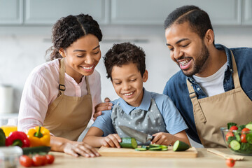 African american mother, father and son cooking on home kitchen