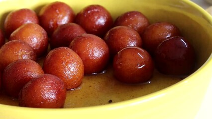 Serving the delectable Gulab Jamun dessert on a rustic plate.