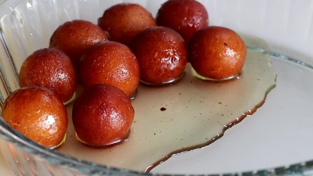 Serving the delectable Gulab Jamun dessert on a rustic plate.
