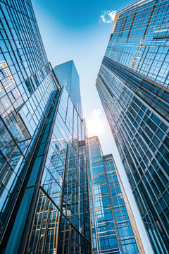 Fototapeta A cluster of tall office buildings closely situated next to each other in an urban environment, showcasing modern architecture and city development.