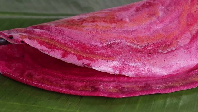 Serving beetroot ghee roast on banana leaf. A colorful, flavorful South Indian Crispy crapes