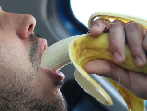 Savoring Nature's Snack: Young Man Enjoying a Banana
