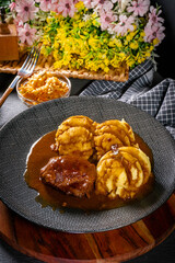 Traditional German braised pork cheeks in brown sauce.