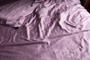 crumpled bed linen color dusty rose on the bed in the bedroom daylight - 766569932