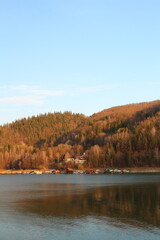 A lake with trees and a rainbow