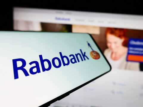 Stuttgart, Germany - 03-16-2024: Smartphone with logo of Dutch banking company Cooperatieve Rabobank UA in front of business website. Focus on left of phone display.