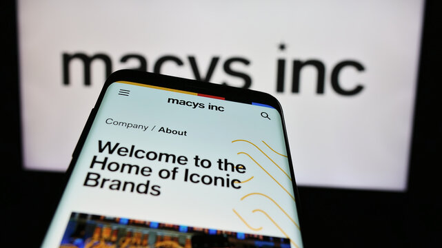 Stuttgart, Germany - 03-16-2024: Mobile phone with website of US department store retail company Macy&rsquo;s Inc. in front of business logo. Focus on top-left of phone display.