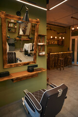 Barber's workplace with mirror chair and hairdressing equipment