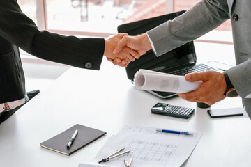 Businessman executive handshake with businesswoman worker in modern workplace office. People corporate business deals concept. uds