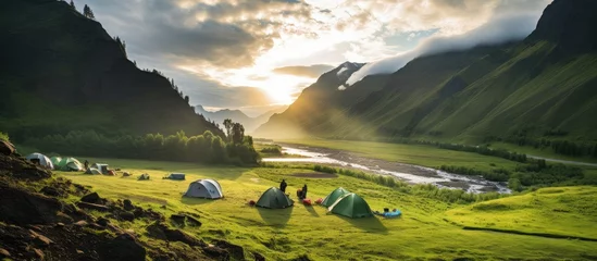 Foto op Aluminium Camping tent near a mountain river in summer.landscape,banner. © inna717
