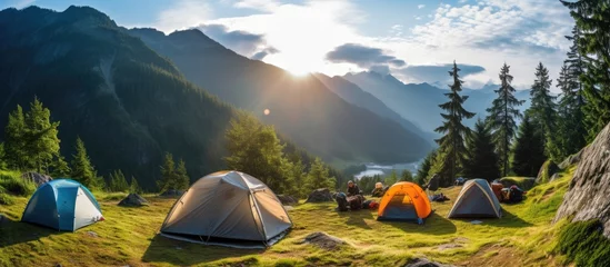 Fototapeten Camping tent near a mountain river in summer.landscape,banner. © inna717