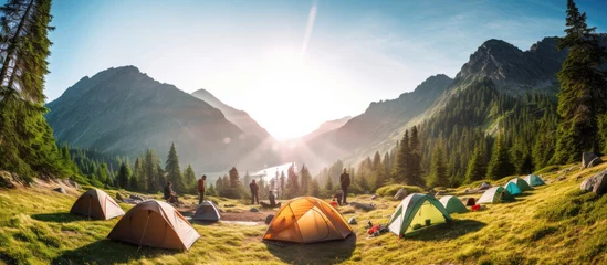 Foto op Canvas Camping tent near a mountain river in summer.landscape,banner. © inna717