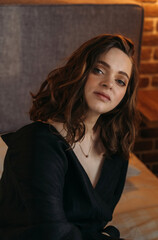 Portrait of a Young Woman Sitting Indoors