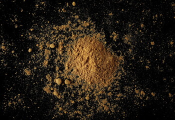 Ginger root powder isolated on black, top view
- 766590107