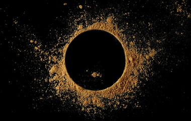 Ginger root powder in shape circle, isolated on black, top view

