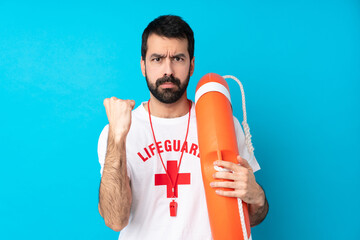 Lifeguard man over isolated blue background with angry gesture