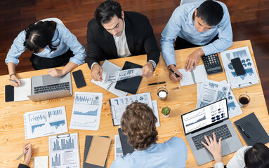 Fototapeta na wymiar Panorama top view diverse group of business analyst team analyzing financial data report paper on meeting table. Chart and graph dashboard by business intelligence analysis. Meticulous