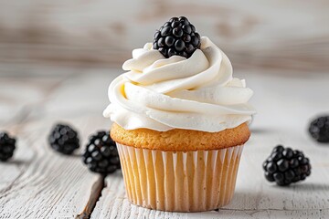 Tasty cupcake with butter cream and ripe blackberries on wooden table - obrazy, fototapety, plakaty