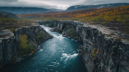 Scenic view of a river running through a canyon next to a mountain. Ideal for travel and nature concepts