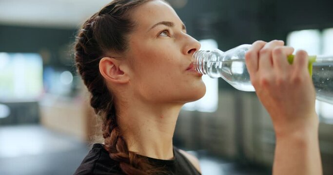 Face, happy woman and drinking water for fitness in gym, healthy body and wellness after training. Club, bottle and thirsty person with liquid beverage for hydration, h2o and nutrition after exercise