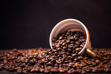 many macro aromatic coffee beans in a cup