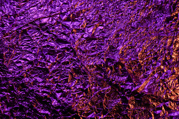 purple foil background with shiny crumpled surface for texture background