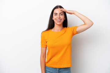 Fototapeta premium Young caucasian woman isolated on white background saluting with hand with happy expression