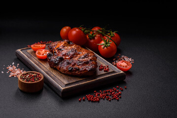 Fresh juicy delicious beef steak on a dark background