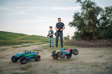Family spending time in nature while playing with remote cars.