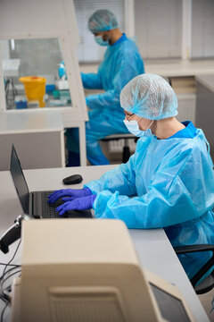 Laboratory employee enters research results into the database