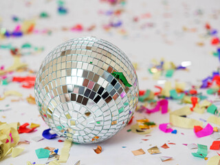 mirror disco ball, around multi-colored paper confetti, party, surprise, on a white background