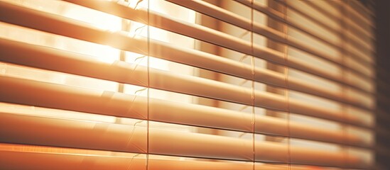 An image showing closed blinds with the sun shining through them, creating a beautiful light pattern in the room