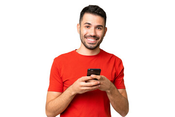 Young handsome caucasian man over isolated chroma key background sending a message with the mobile