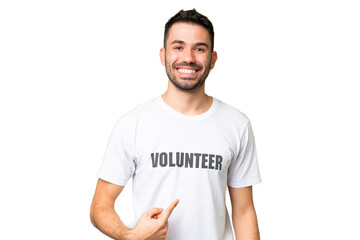 Young volunteer caucasian man over isolated chroma key background with surprise facial expression