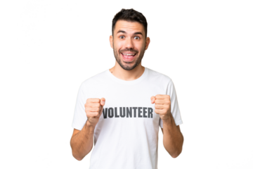 Young volunteer caucasian man over isolated chroma key background celebrating a victory in winner position