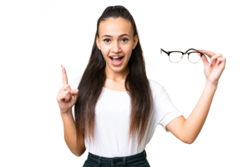 Young Arabian woman holding glasses over isolated chroma key background pointing up a great idea