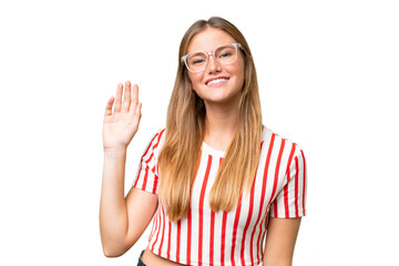 Young beautiful woman over isolated background saluting with hand with happy expression - 766620749